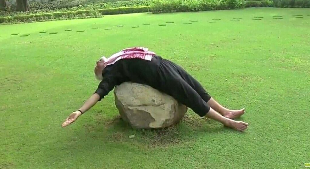 narendra modi funny yoga pose stretching on a rock like sleeping