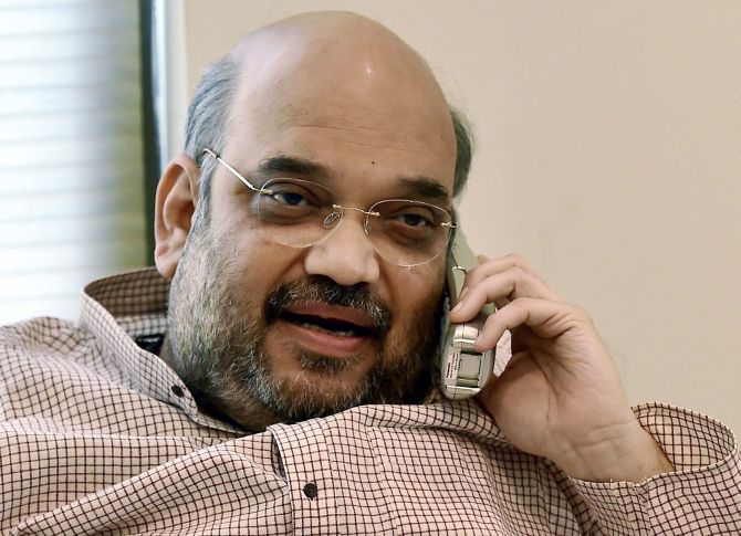 Amit shah talking on phone calling to someone