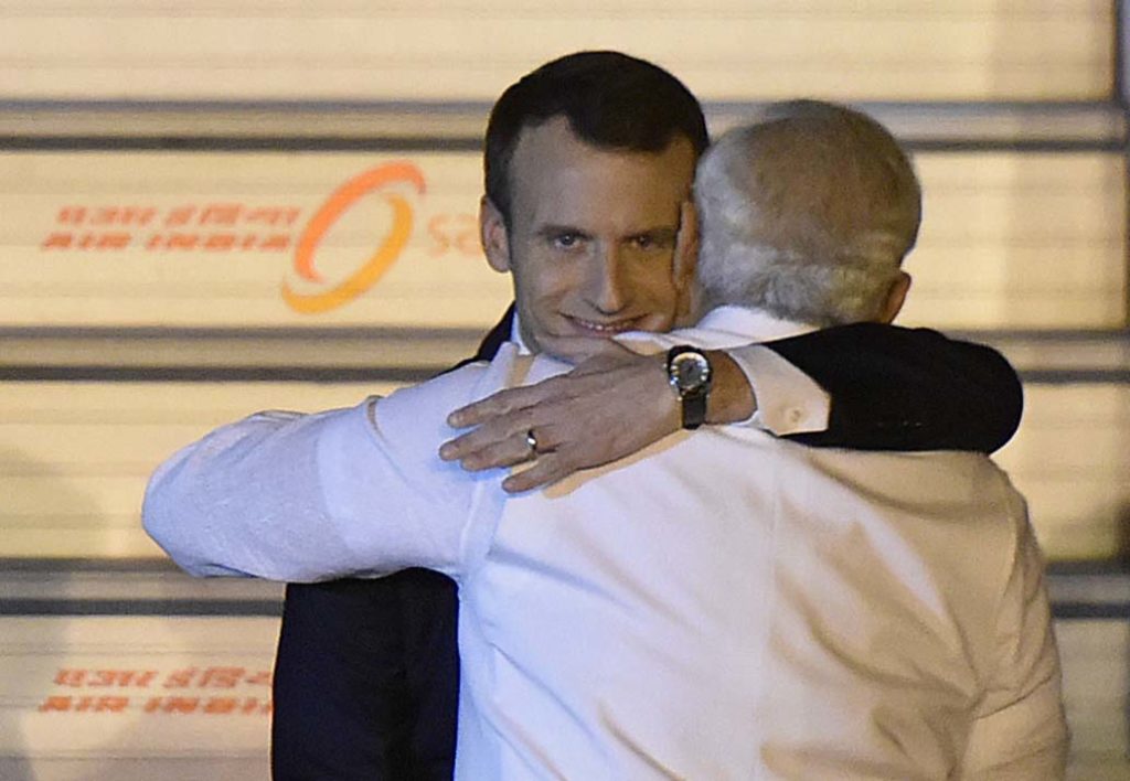 Emmanuel Macron grinning while hugging PM Narendra Modi meme template