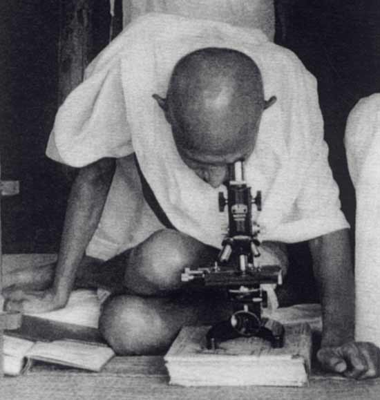 mahatma gandhi sitting down folded legs looking through microscope funny photo meme