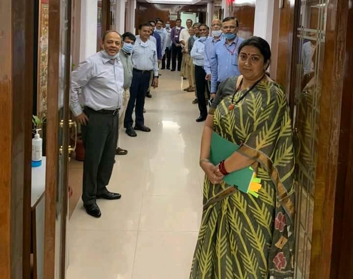 Smriti Irani standing with officers at the office door